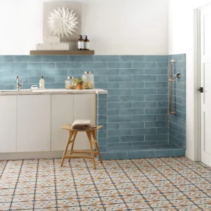 Mint blue subway tile on the wall and multi-colored patterned tile on the floor | Shoreline Flooring