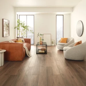 COREtec Luxury Vinyl in a dark brown wood tone in a bright living room | Shoreline Flooring