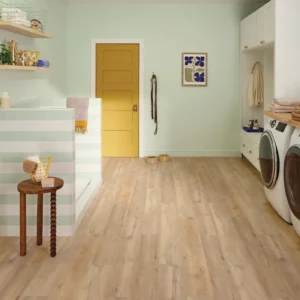 COREtec Luxury Vinyl in a light blonde wood color in a laundry room | Shoreline Flooring