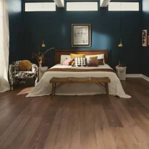 COREtec Luxury Vinyl in a medium brown wood tone in a bedroom | Shoreline Flooring